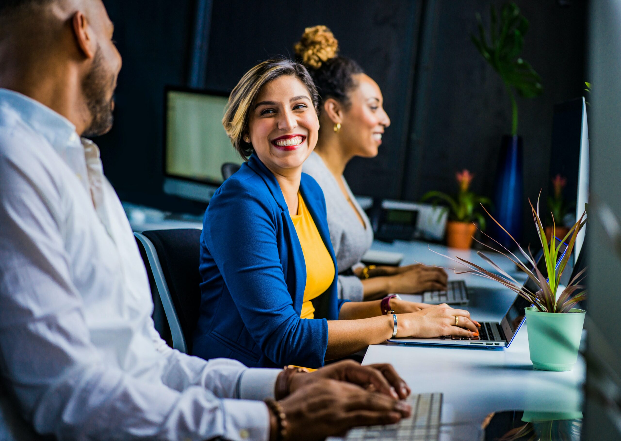 Happy women in blue blazer.. Compliance when going global - Africa HR Solutions