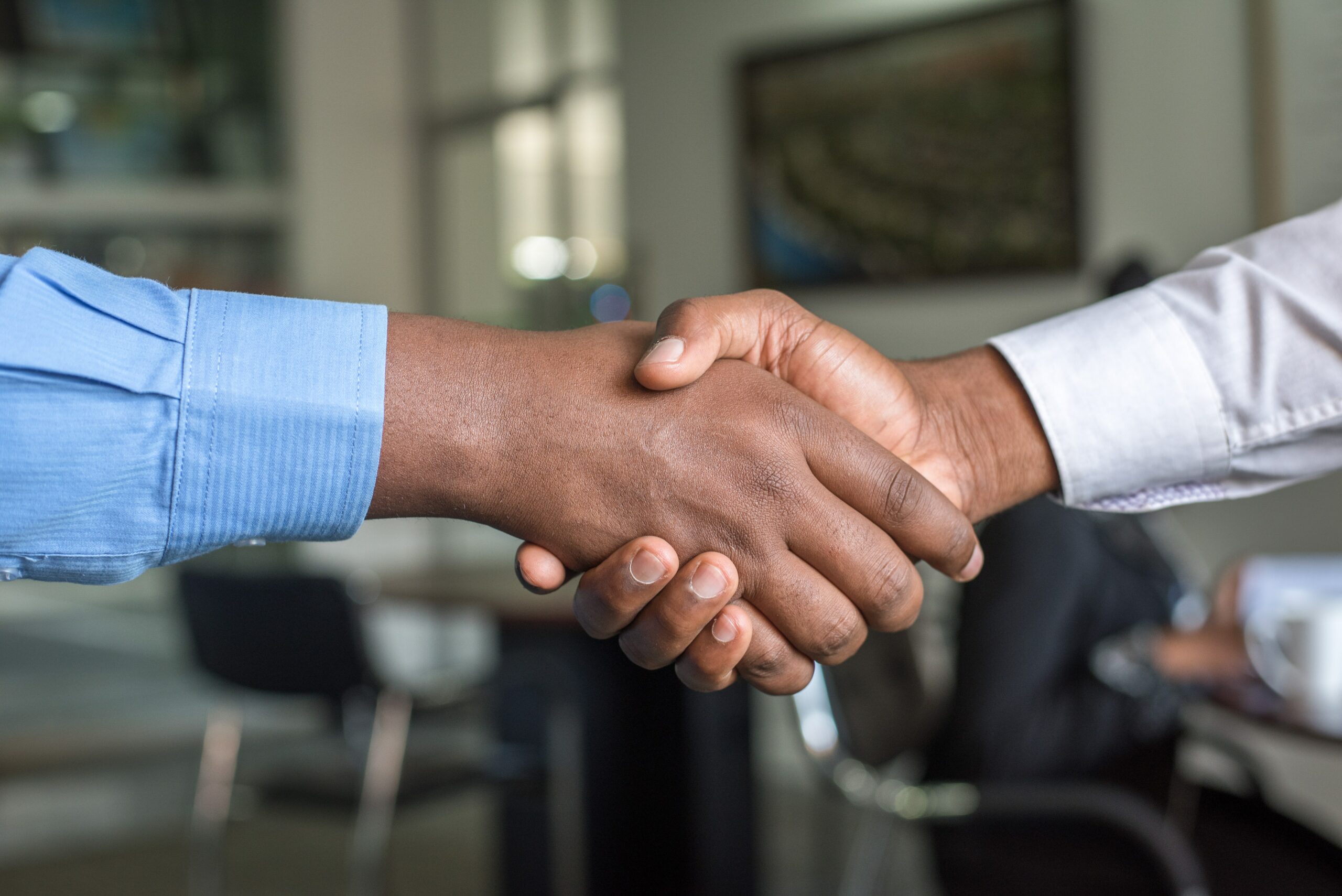 Dark skinned men shaking hands
