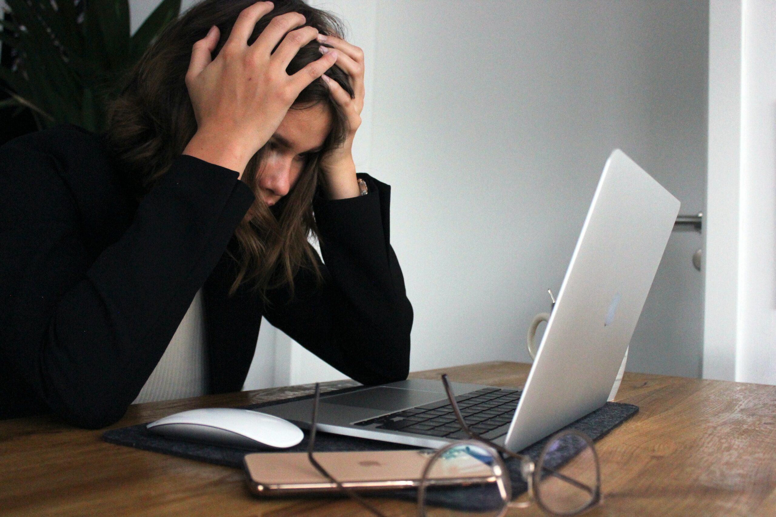Young woman stressing over laptop computer