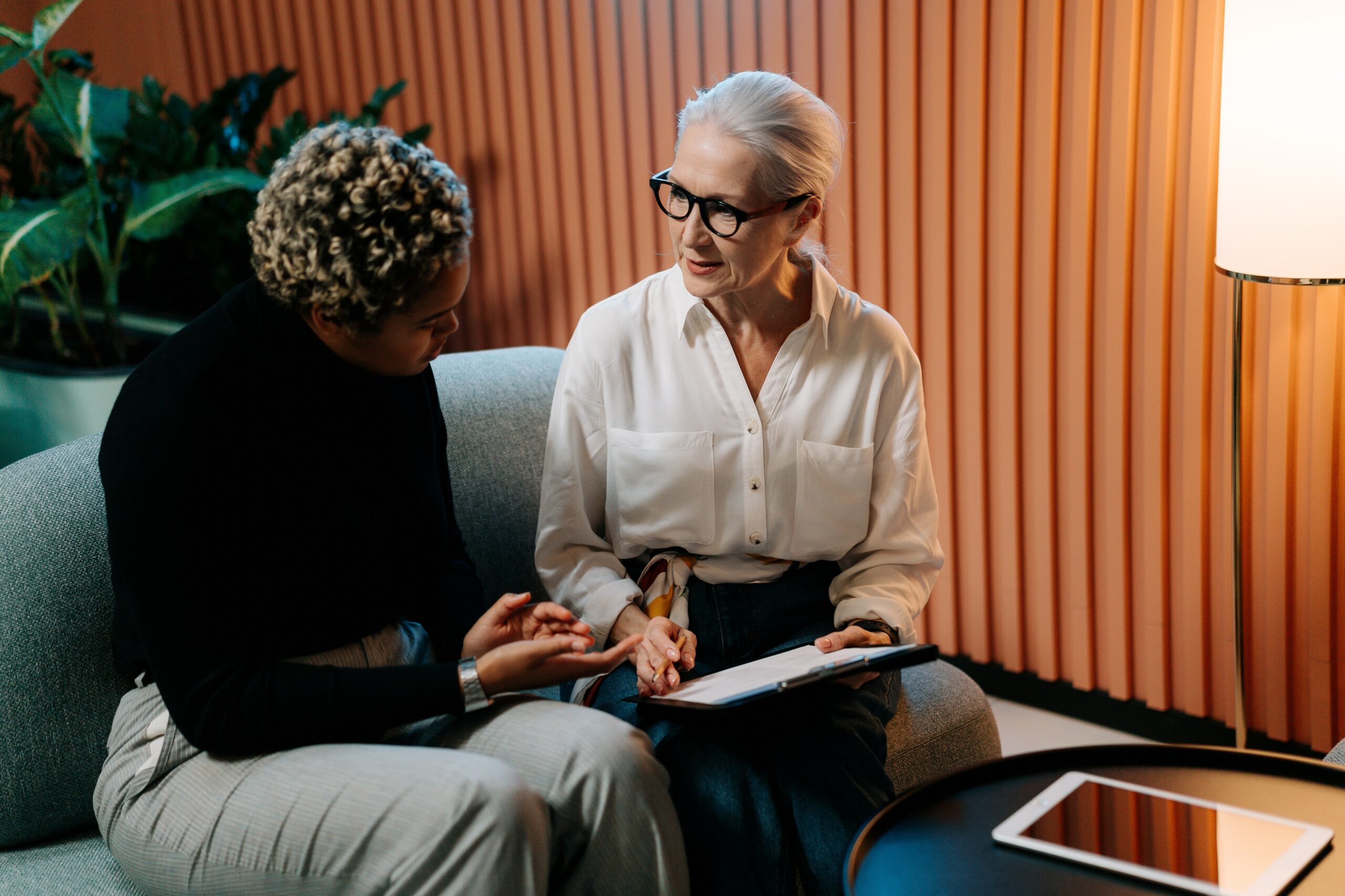 Caucasian woman talking to a younger woman