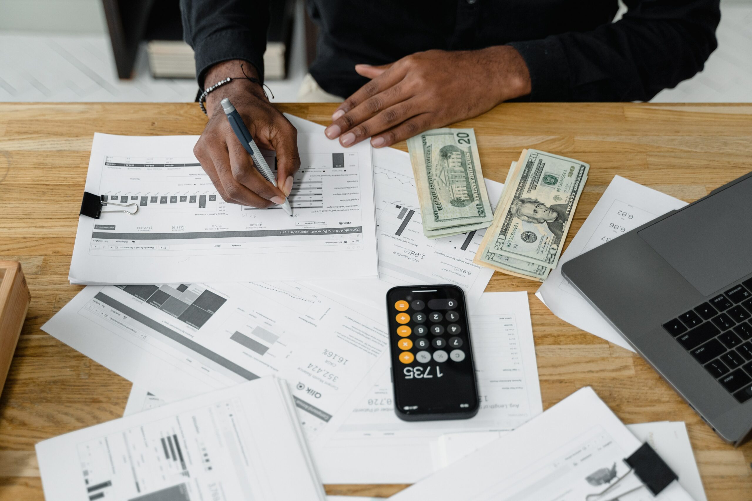 Desk of someone doing payroll counting money